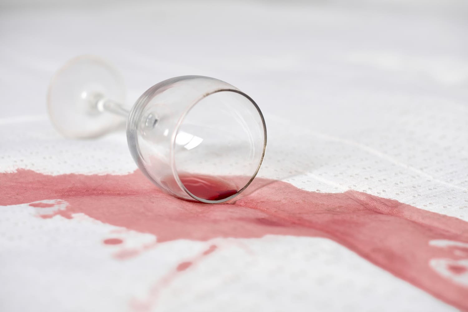 Wine glass accident on white surface